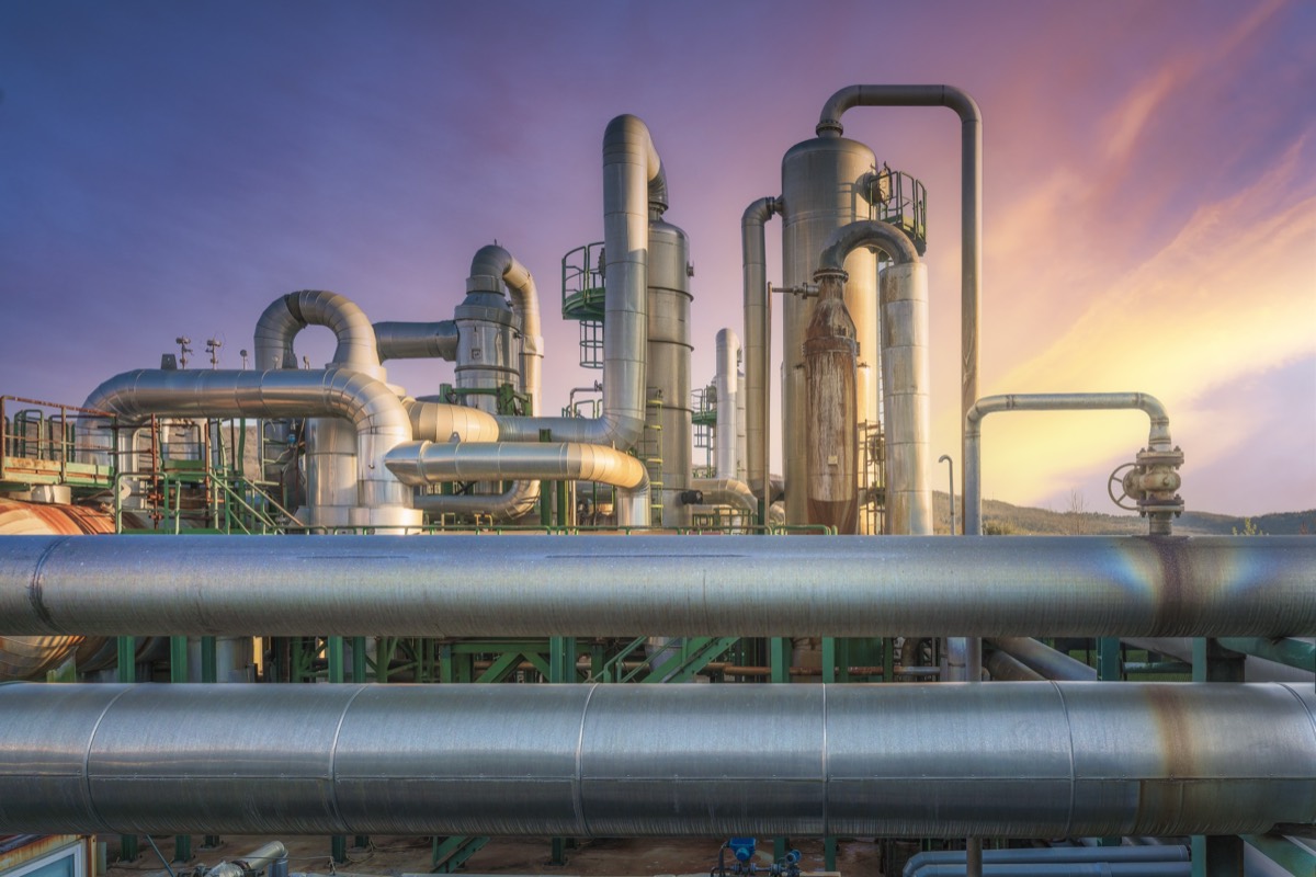 Industrial plant pipelines at sunset