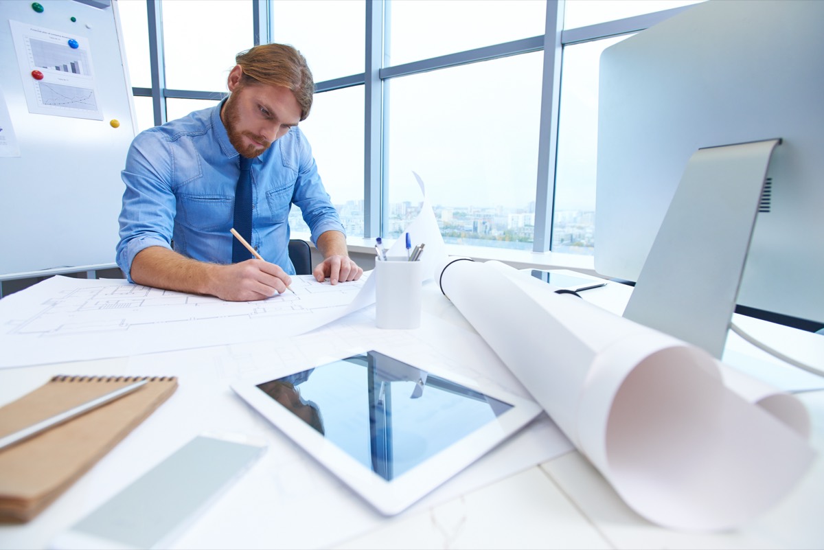 Engineer working on technical drawings